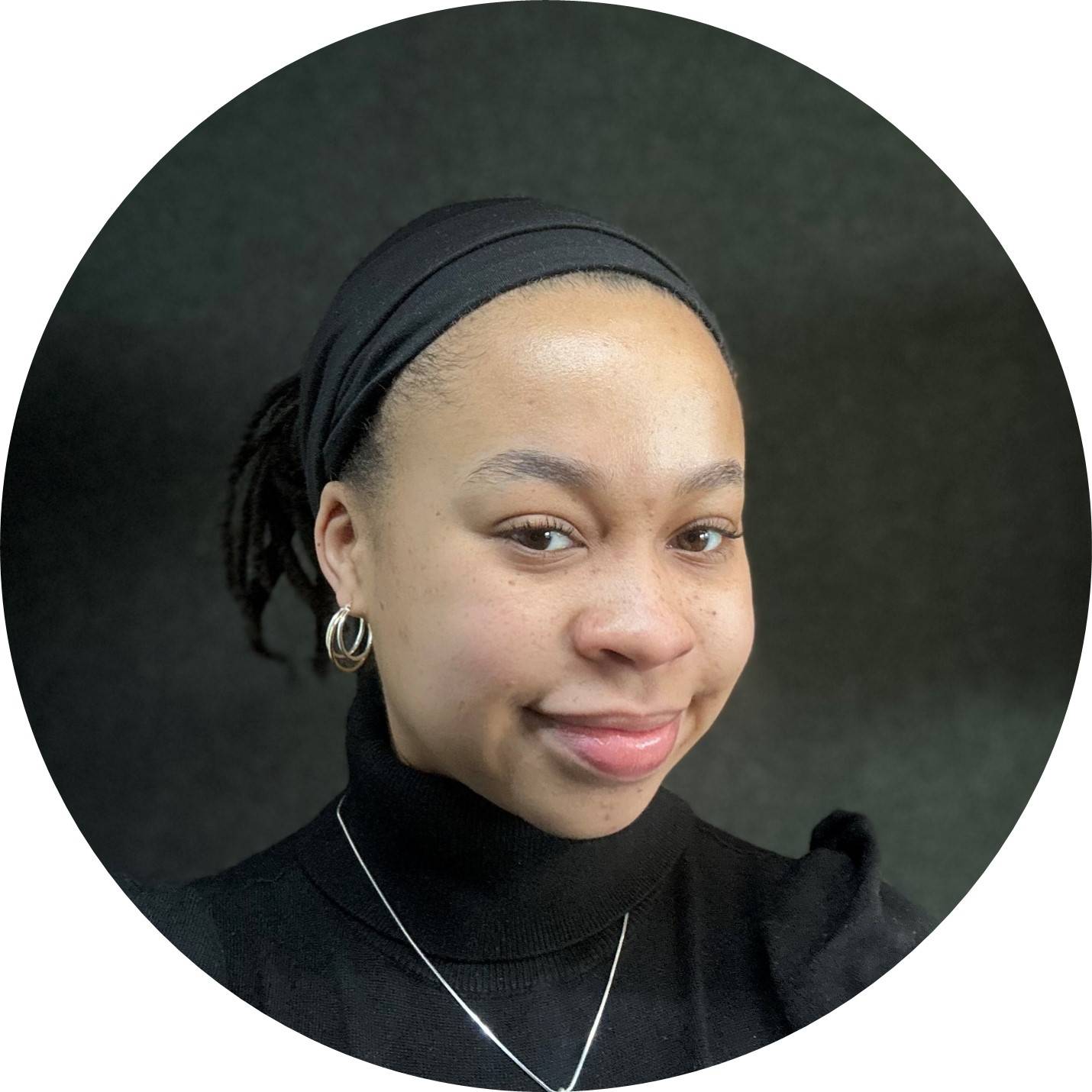 Taylor wearing a turtle neck and ear rings